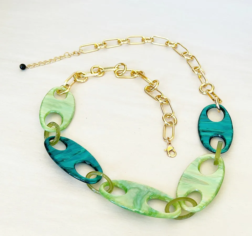 Bold statement necklace with acrylic green on green oval front link accents